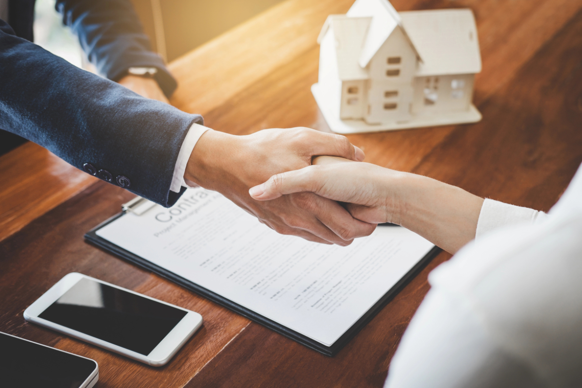 Real estate agent and customers shaking hands together celebrating finished contract after about home insurance and investment loan, handshake and successful deal